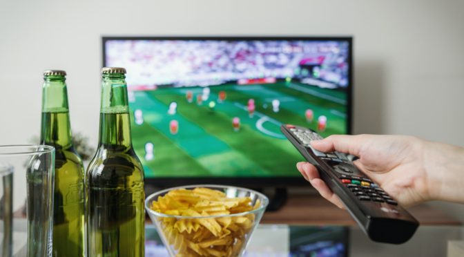 watching sport on tv with beer and snacks